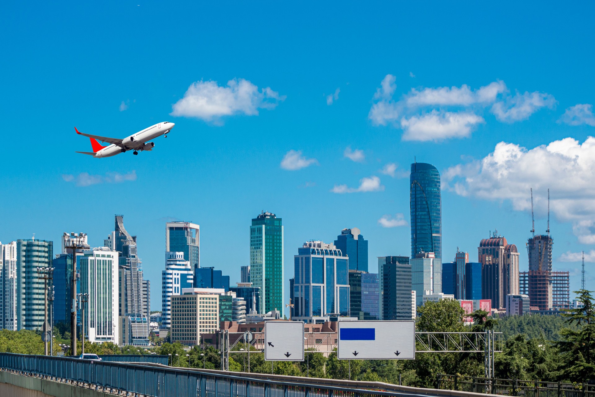 Passenger plane taking off over the city